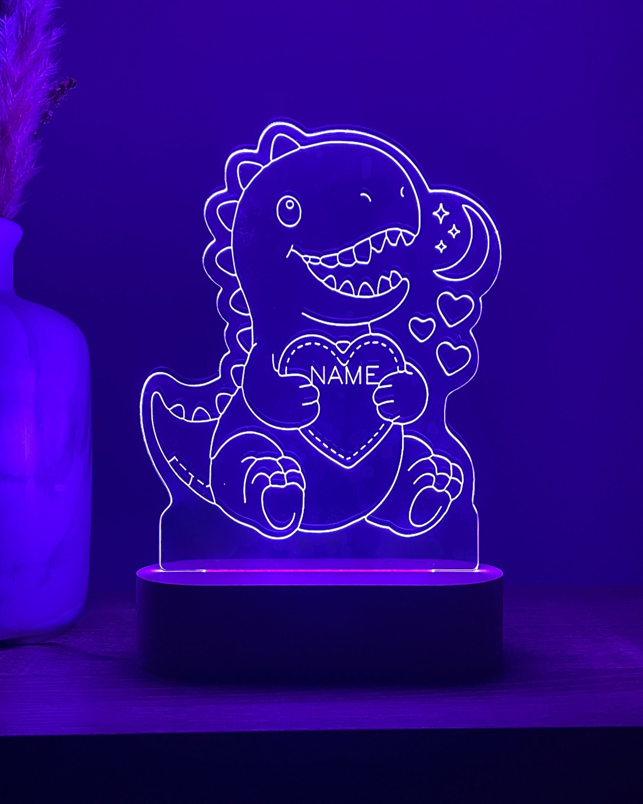 DreamLight™-nachtlampje met paarse verlichting, een T-rex en de tekst NAME
