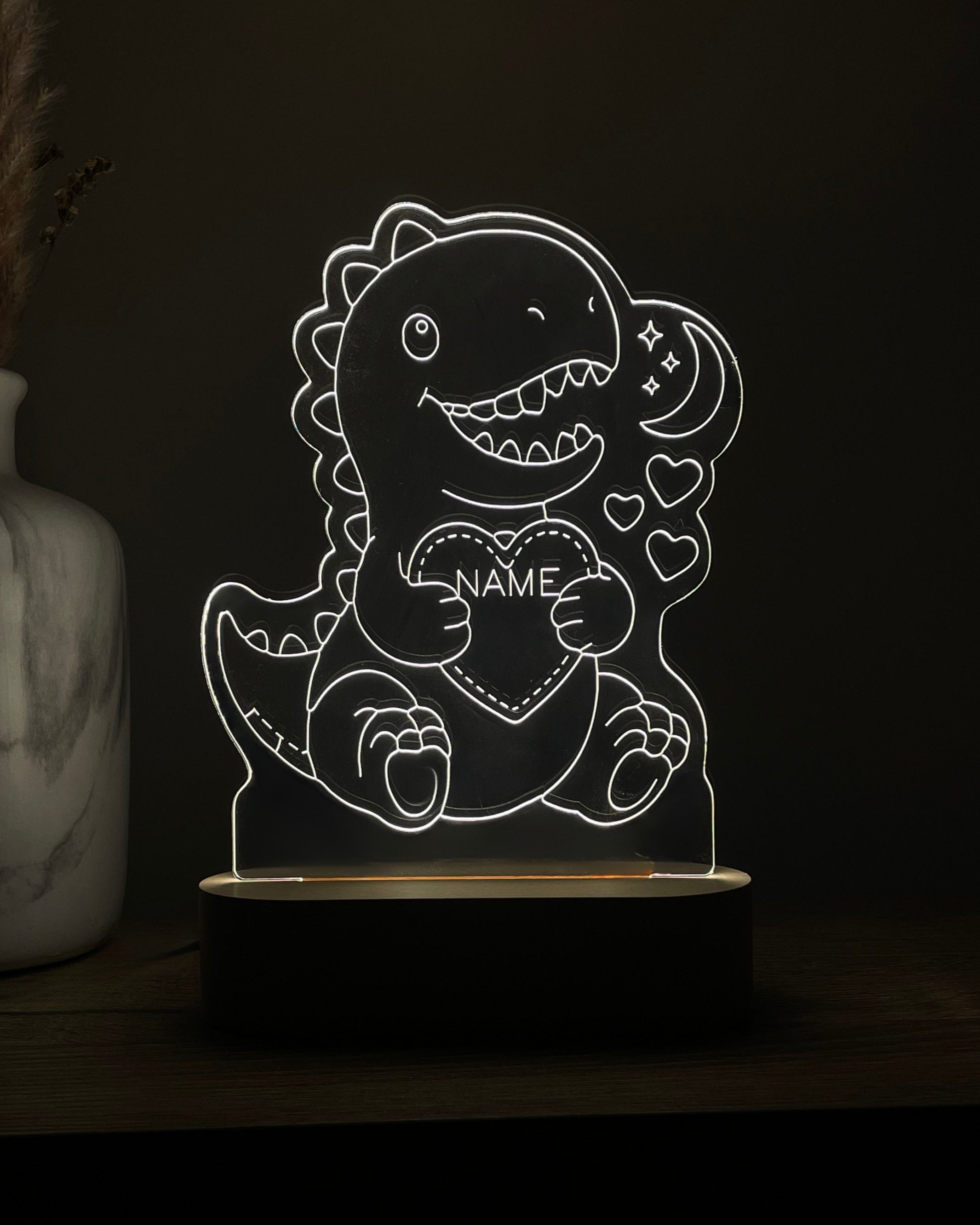 DreamLight™-nachtlampje met witte verlichting, een T-rex en de tekst NAME