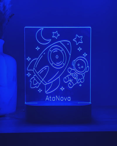 Video van een blauw verlicht DreamLight™-nachtlampje met raket, astronaut en de tekst AtaNova